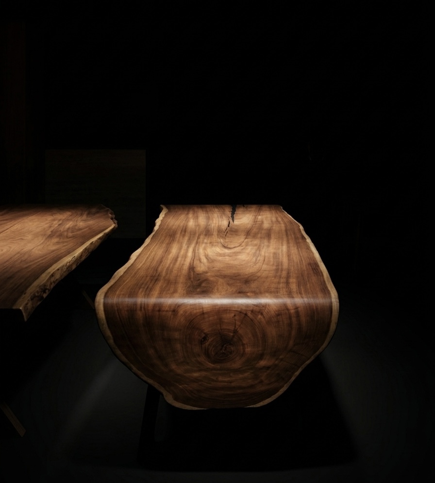 Sculptural live-edge waterfall table in dramatic low light